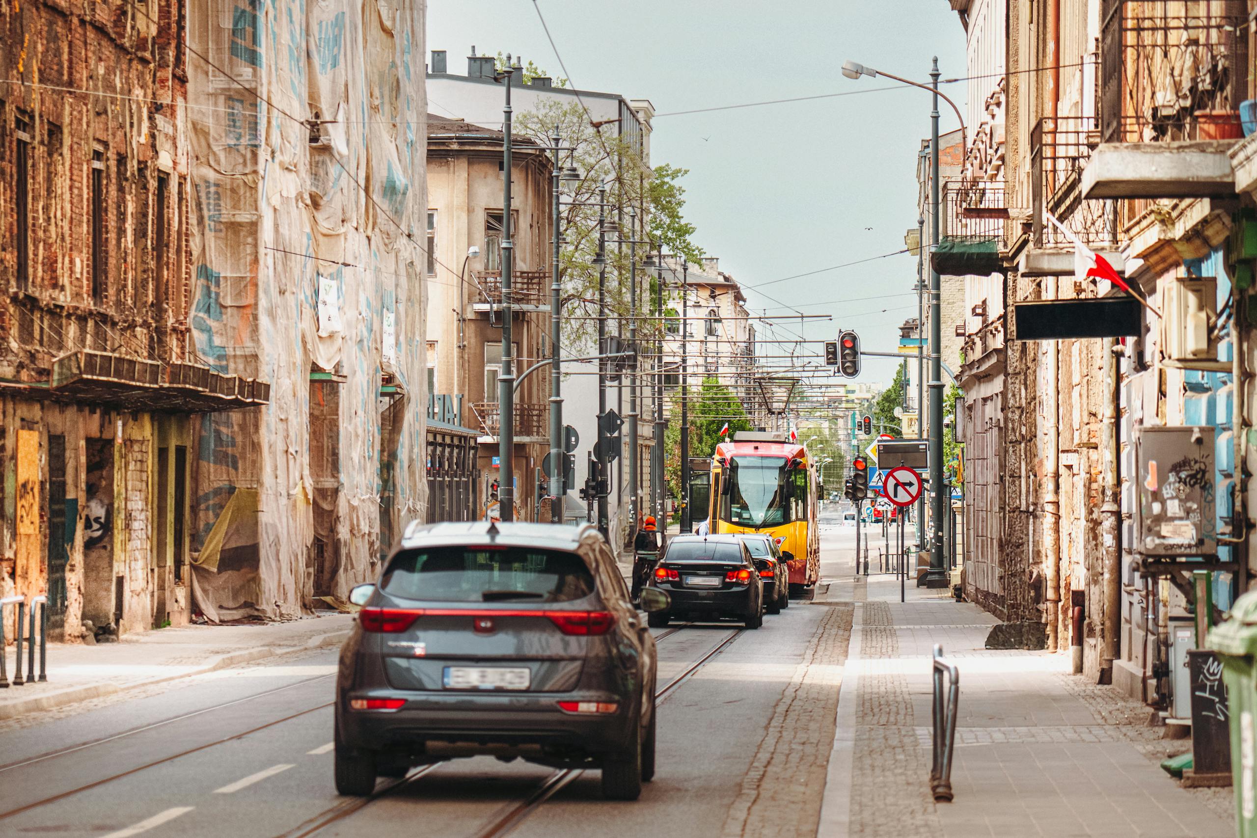 Urban street under renovation with cars and tram in European city